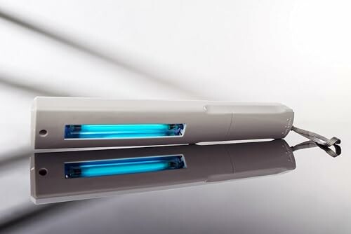 Portable UV light sanitizer with reflection on surface
