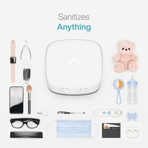 UV sanitizer surrounded by various items like a watch, keys, phone, and baby bottle.
